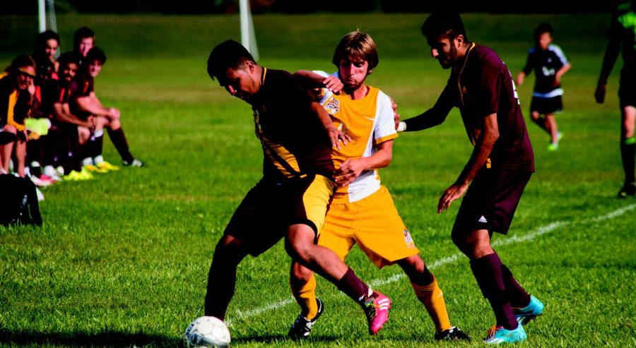 Photo by Alex Reigh
Sophomore Mid-fielder Davide Di Poce (11) battles two Jackson Forwards for possession of the ball on
Sunday Sept. 20.