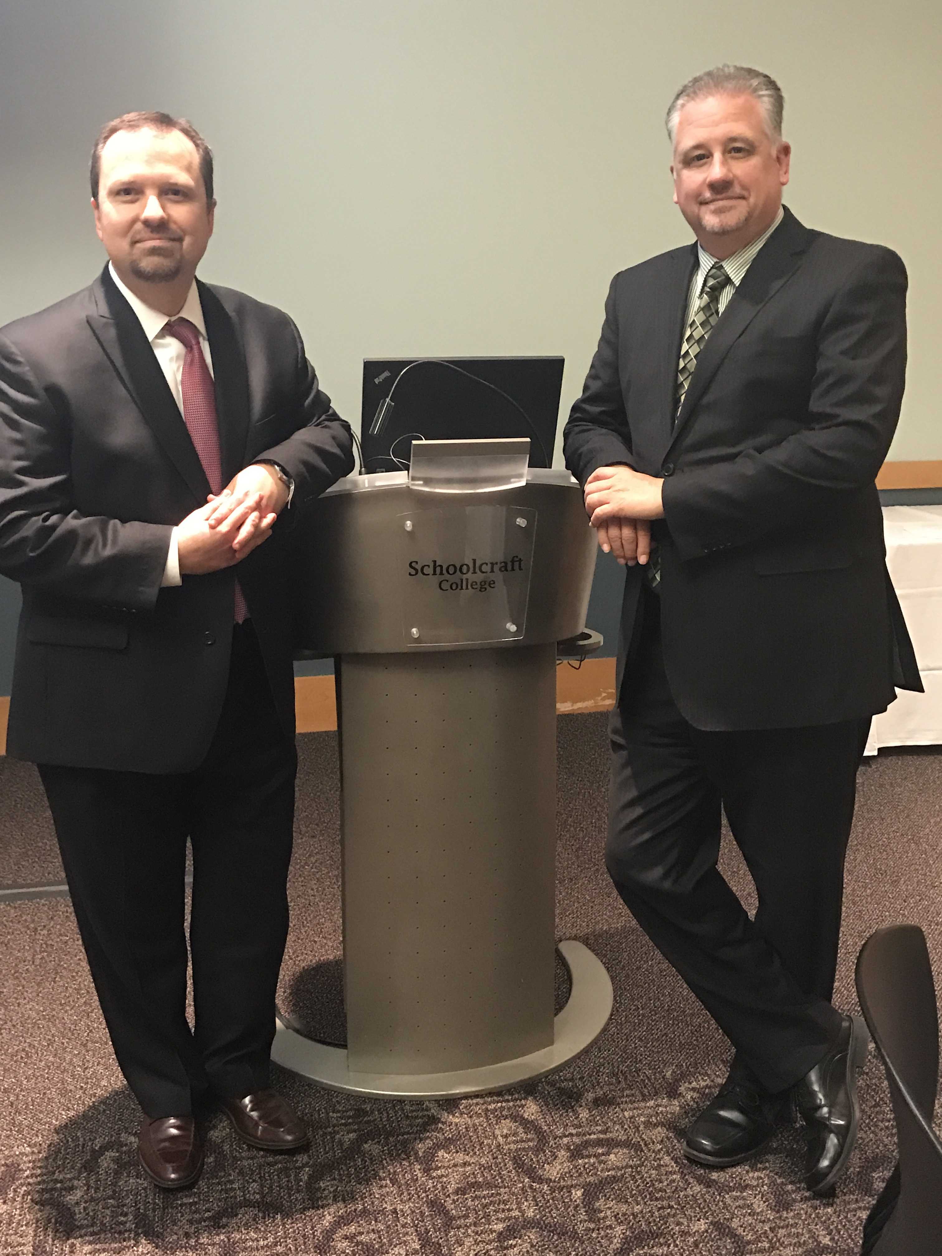 Timothy Conselyea and Roger Folkman standing on either side of a podium