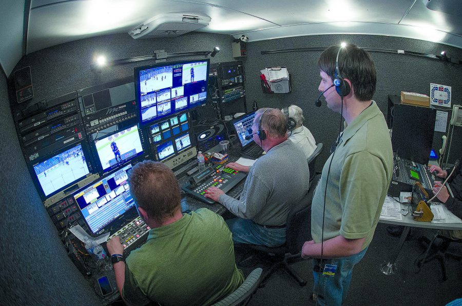 Kieth Dotson, Richard Sherby, Robert Sherby and Suzanne Sherby process footage at USA Hockey game in the new media production truck.