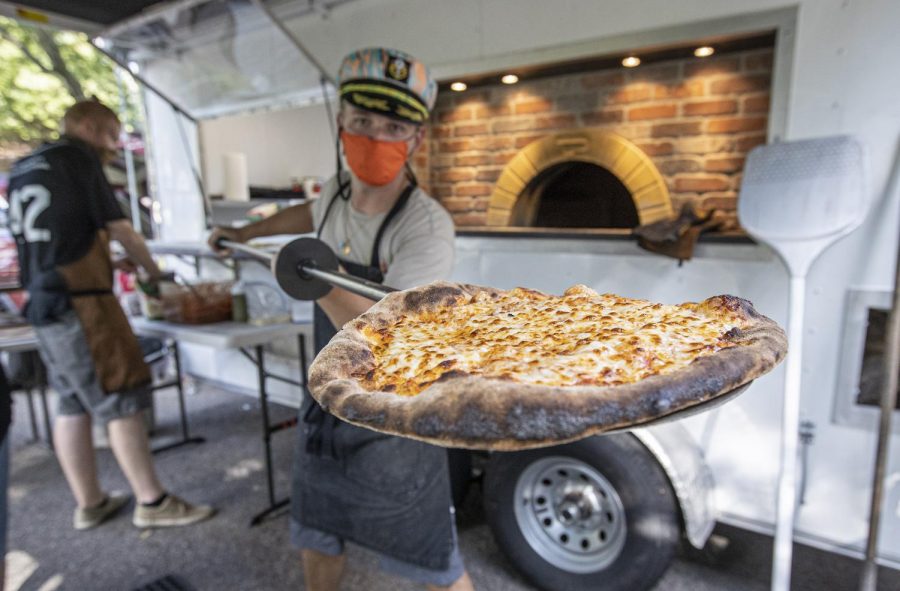 Nick Mannisto shows off his cheese pizza he created in his mobile food truck. (Courtesy Photos)