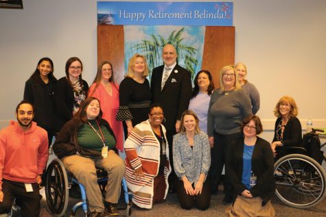 Schoolcraft Registration Associate, Brenda Eleson (top row in the center wearing black) poses with members of the Registration Office Staff at her recent retirement celebration on Jan. 28, 2022. Eleson retired after 43 years of service to the college.