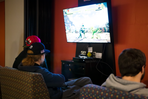 Students Steven Parnin, Robert Ardis and John Sotiropoulos play video games in the lower level VisTaTech Center during a recent Project Playhem meeting.