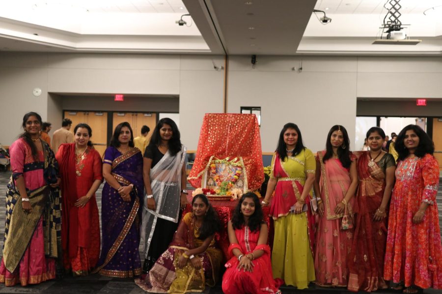A group of Navratri attendees pose for a photo, October 8, 2022  in the DiPonio room of the VisTaTech Center.