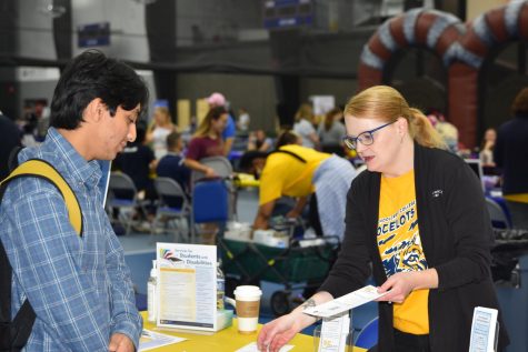 Liz Smith from Student Relations speaks with student at School Daze on Monday, September 19, 2022 inside the Mercy Elite Sports Center.