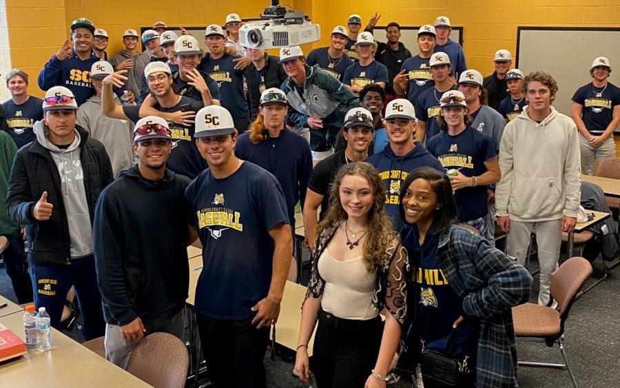 Phi Theta Kappa President Madison Loving (front right) and Vice President of Leadership Melia Conners pose for a group photo with the Mens baseball teaam at the conclusion of the “burnout” seminar on Oct. 31, 2022.
