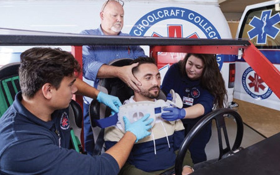 EMT students practice a simulated emergency response to car crash on live subject inside the EMT Lab.