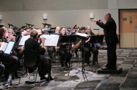 Director Paul Michalsen and his wind ensemble prepares for another number to perform in the Vistatech Center, DiPonio Room on Saturday, April 15, 2023.
