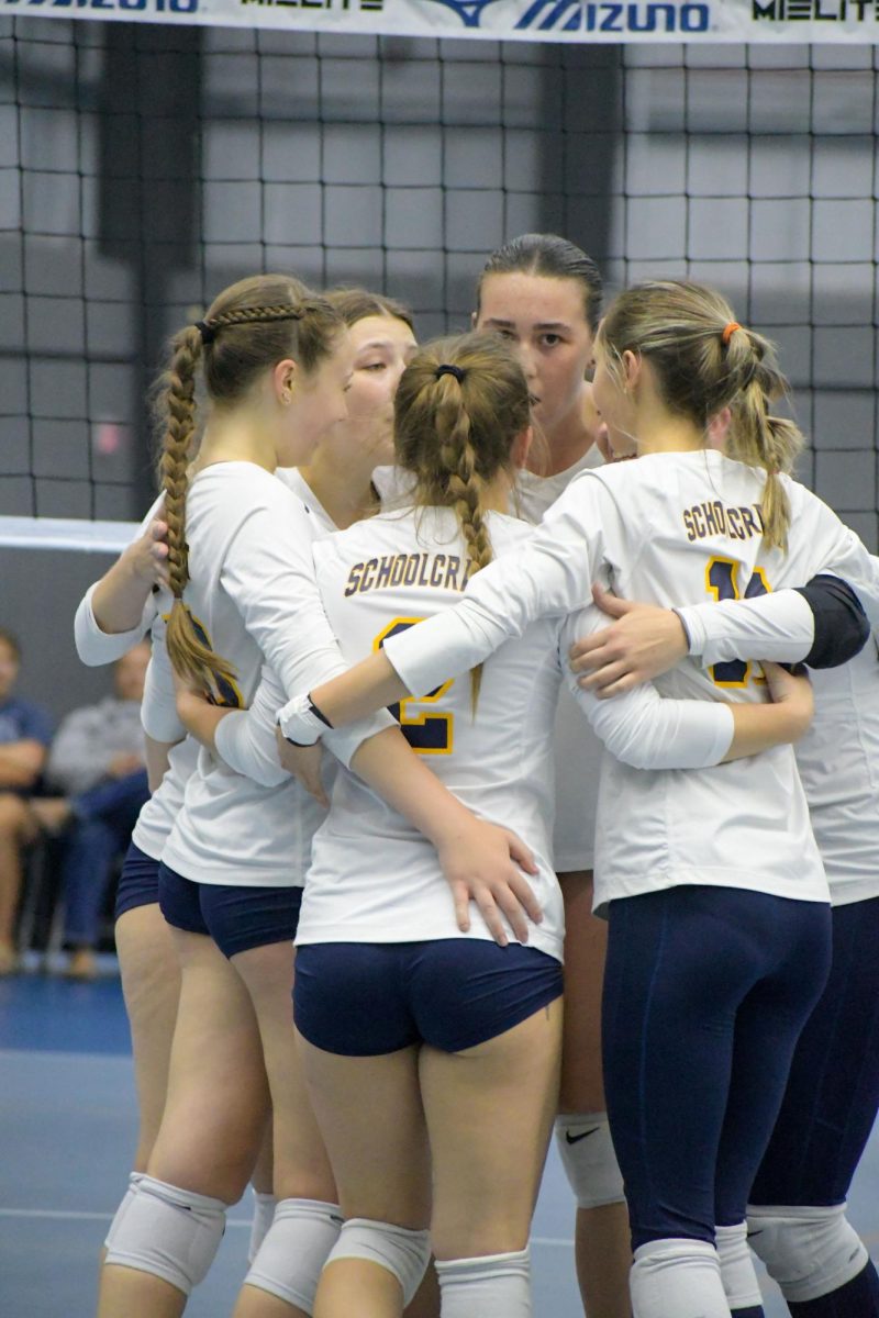 The 2023 Women’s Volleyball team huddles during a timeout at a recent match. This squad prides itself on teamwork and chemistry on and off the court.