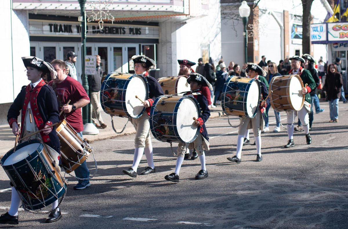 Plymouth Fife and Drum Corps march through downtown Plymouth, playing instruments synchronously and leaving the public excited during the Plymouth Ice Festival Feb. 3, 2024.
