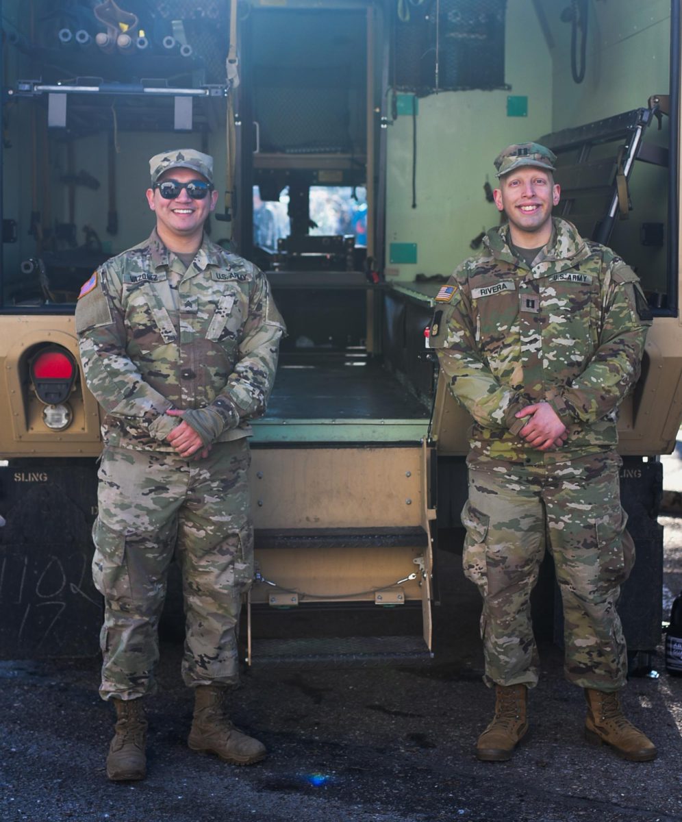 Sergeant Nicholas Vazquez (left) and Captain Nicholas Rivera (right) pose for a photo in front of their Army truck at the Plymouth Ice Festival Feb. 3, 2024 in downtown Plymouth, Michigan.
