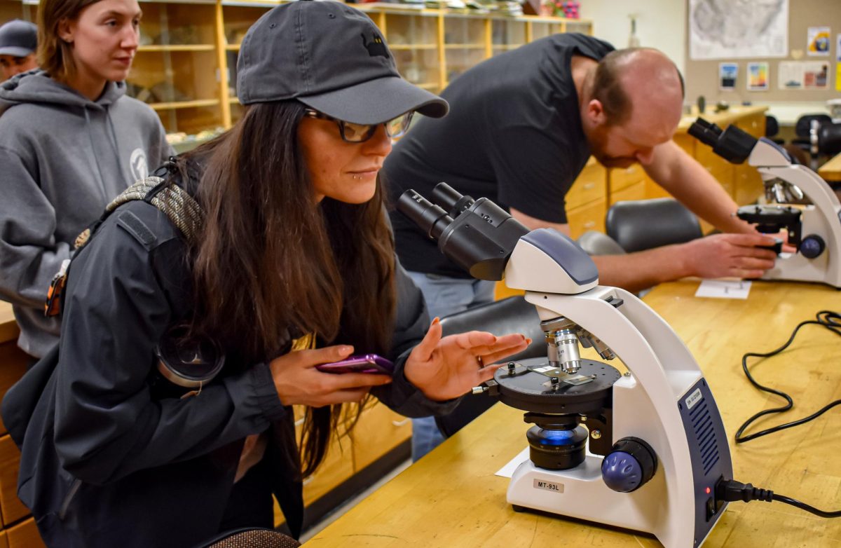 Attendees adjust the slides for better view under the microscopes at the Optical World of Minerals workshop on March 14, 2024 from 6-7 p.m. in the Forum Building.