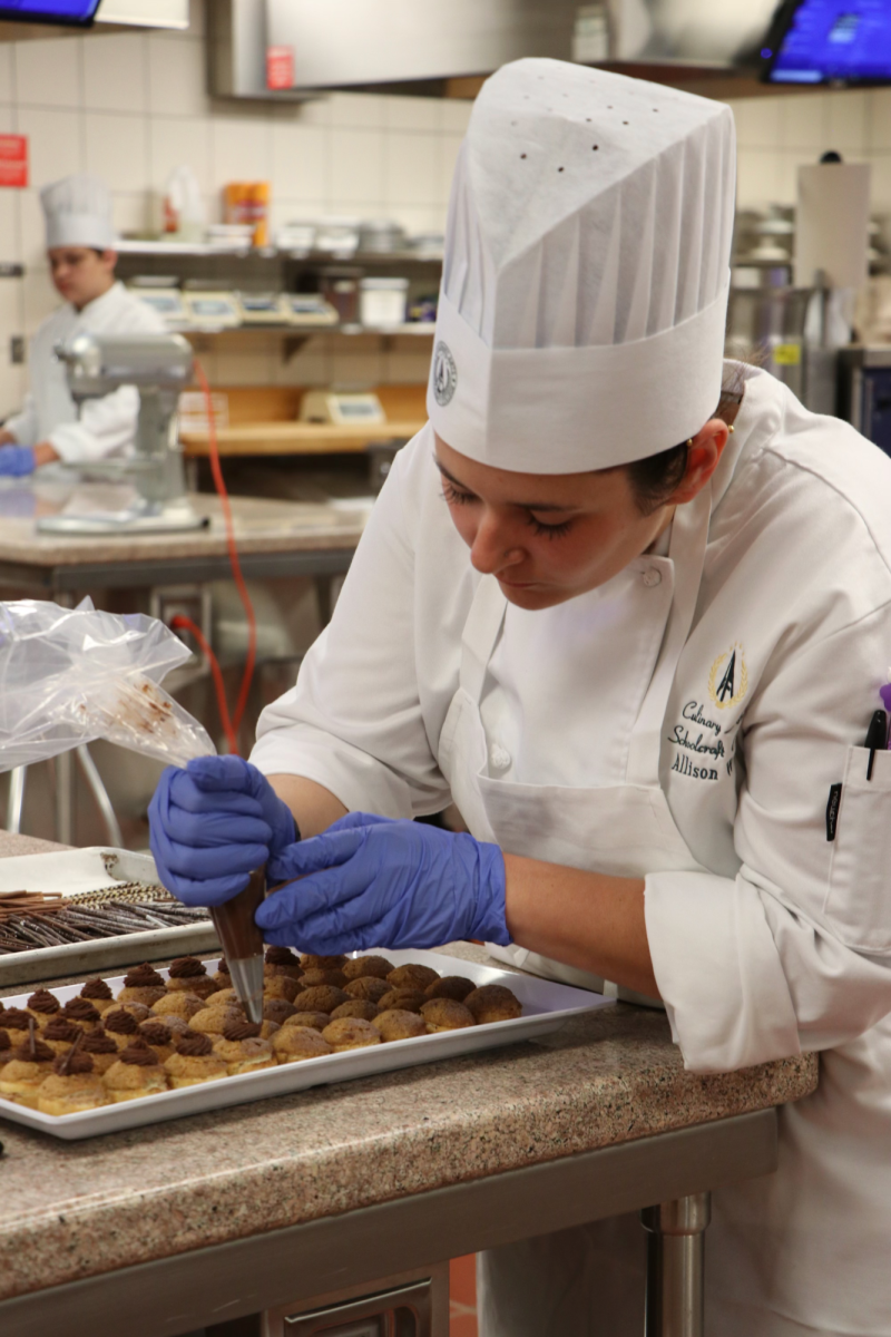 National Student Pastry Chef of the Year Allison White works on the finishing touches of a pastry dish in the Culinary Arts kitchens.