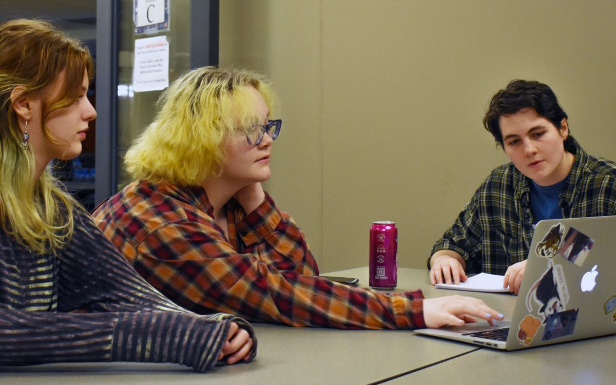 Linguistic club members and President Sam Varble (right) work on figuring out a puzzle on Langle during a recent club meeting.