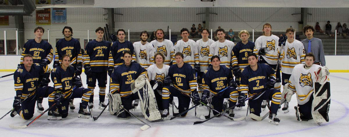 The 2024-25 Schoolcraft Men’s Ice Hockey team pose for a team photo on the ice after their Blue vs Gold game. 