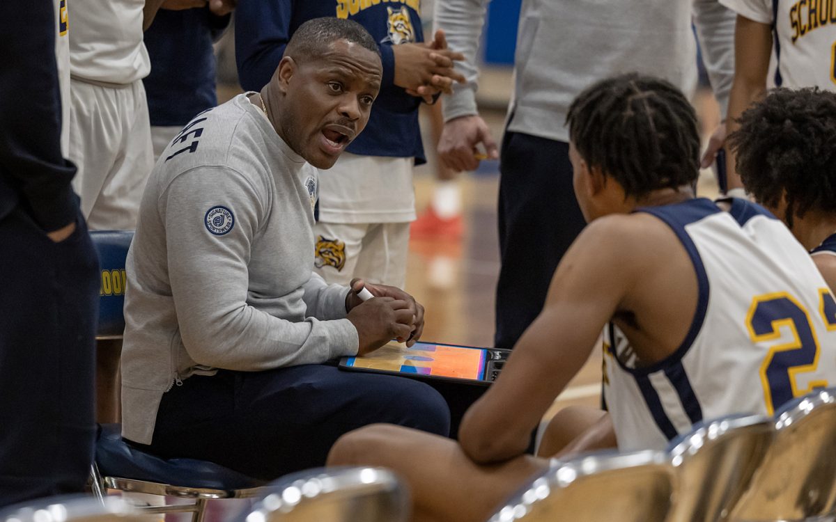 Schoolcraft Men’s Basketball Head Coach EJ Haralson talks to his player during a time out. Haralson is entering his third year as head coach and focuses on instilling confidence within his players. (Photo Courtesy of Schoolcraft College)