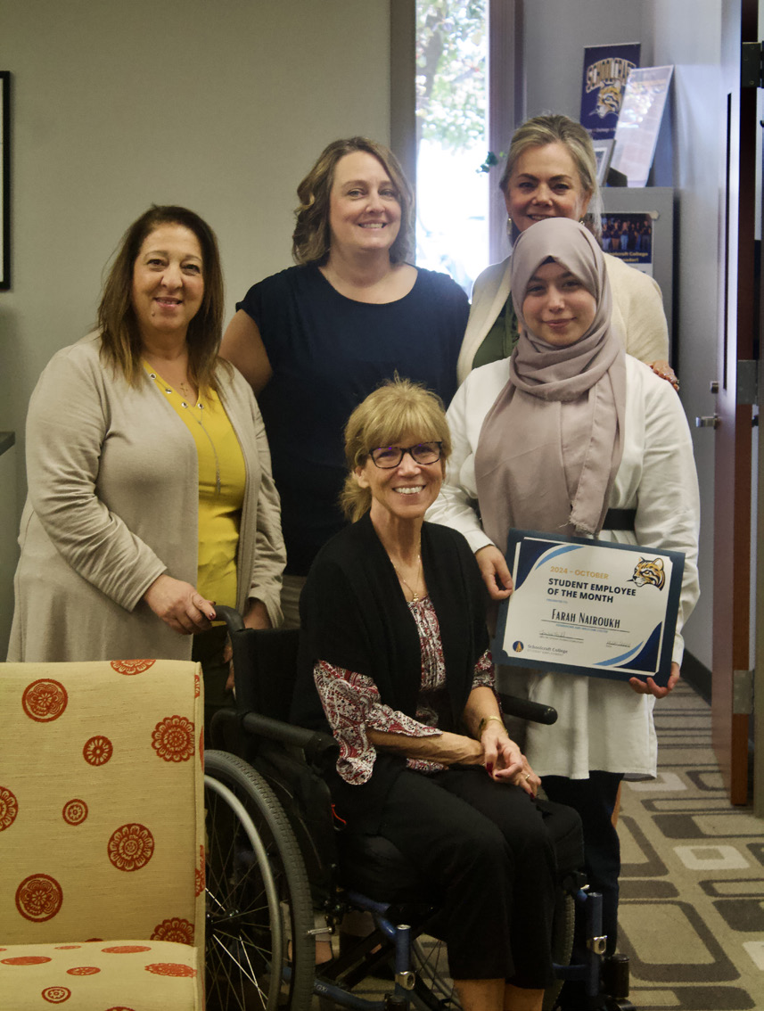 Admissions Office Student Employee Farah Nairoukh (far right middle) stands for a group photo for the Admissions Office team.