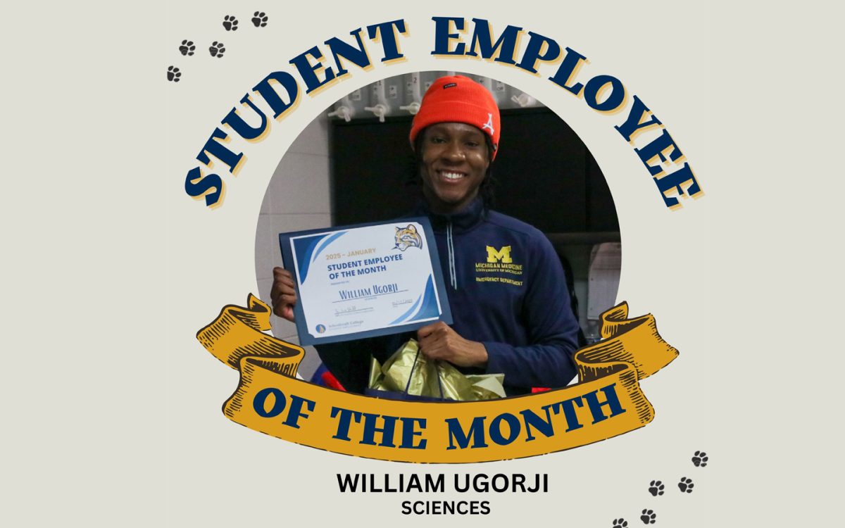 William Ugorji proudly standing with his student of the month award.