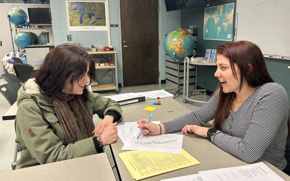 Earth Science professor 
Amy Parsons, right, works one-on-one with one of her students during her Earth 110 class inside the Forum Building.