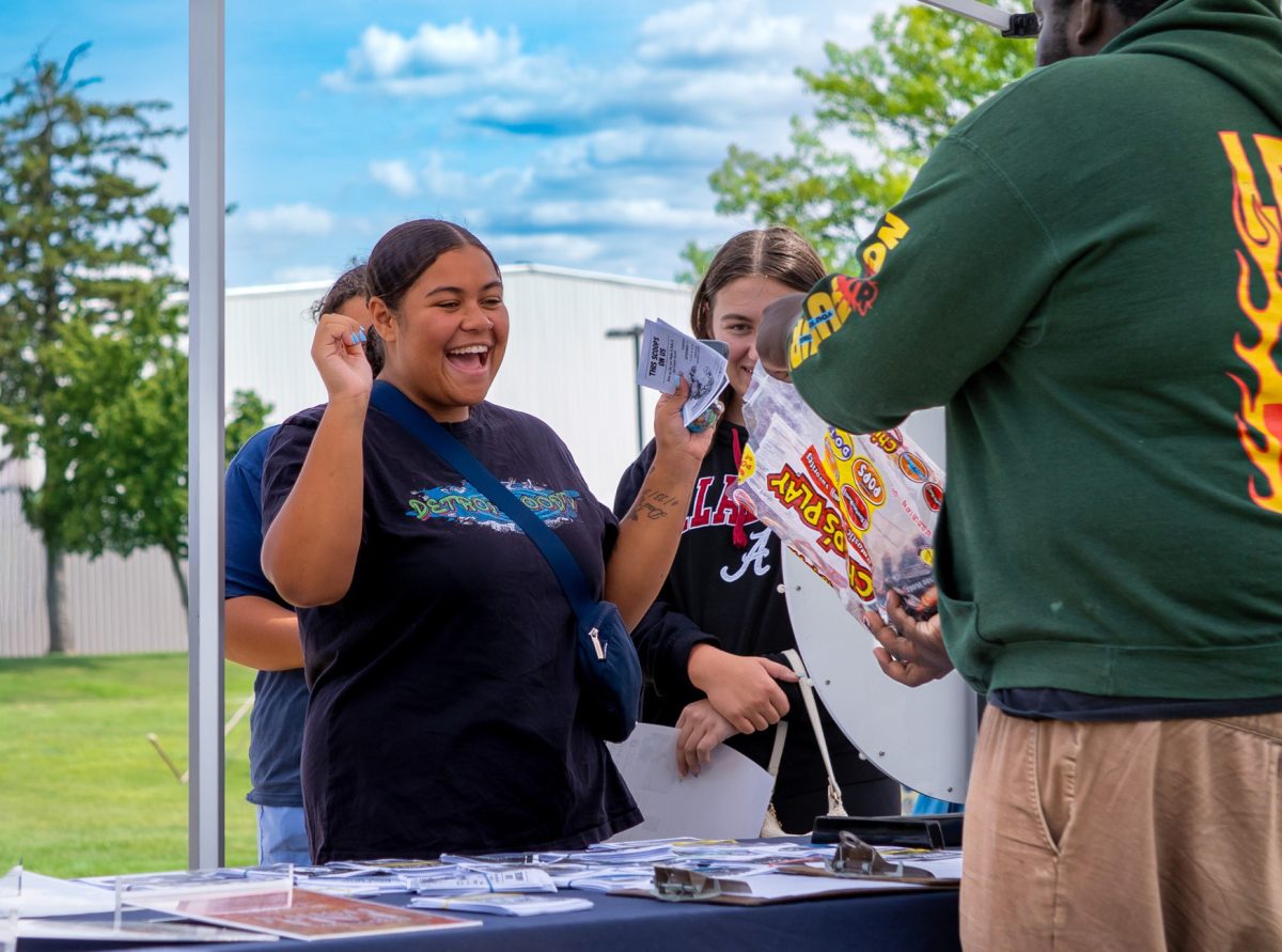 A student participating in spin the wheel at the Student Activities Office table gets excited after winning a prize at Ozzypalooza on Wednesday, August 27, 2025.
