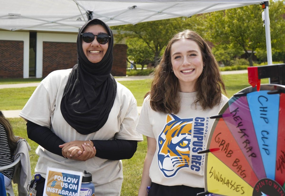 Recreational Services student employees, Wafa Mangla and Abigail pose for a photo at the rec services table at Ozzypalooza on Wednesday, August 27, 2025. They were giving out products for following the fitness center on social media.