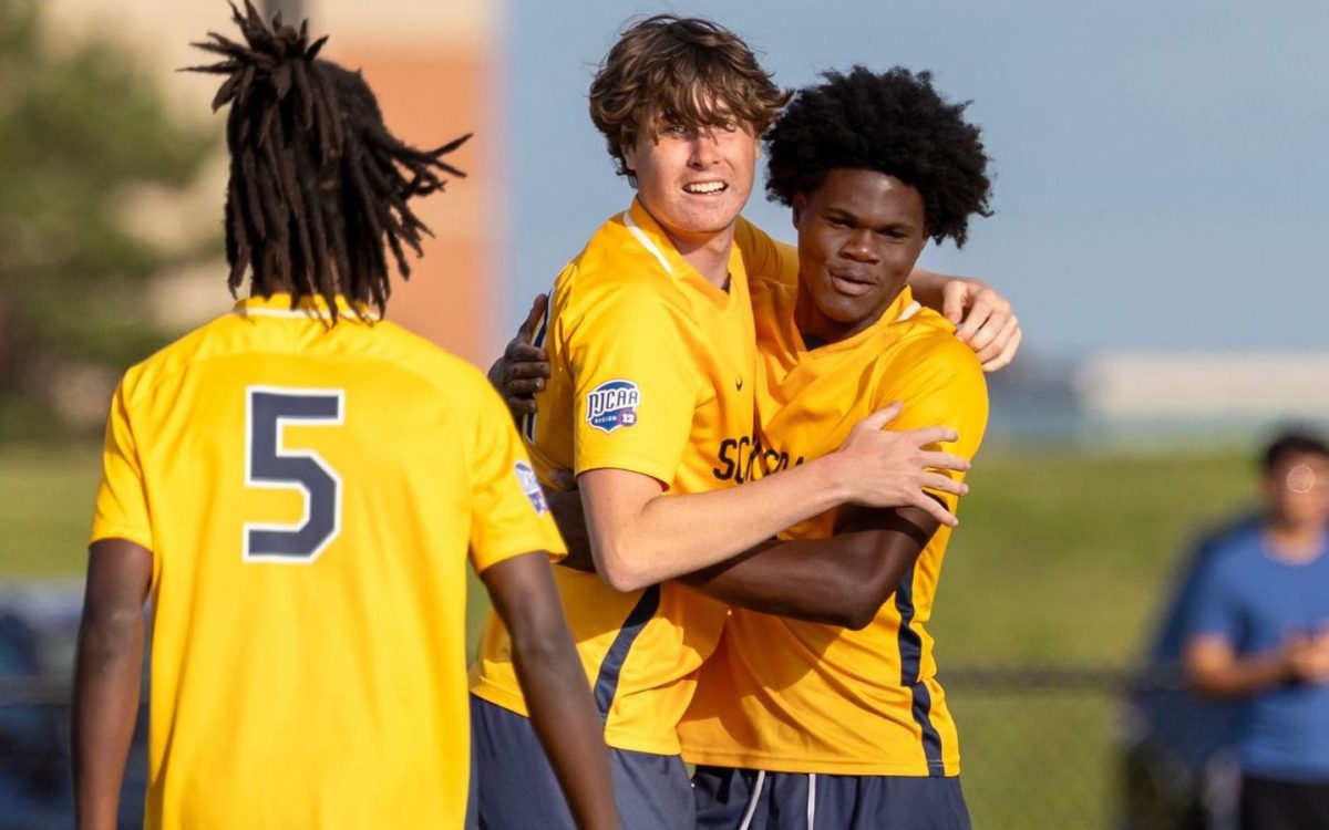 Schoolcraft's Justin Vivier (center) celebrates with teammates after scoring in the 57th minute against South Suburban College on August 29, 2025. (Photo courtesy of Schoolcraft Athletics)