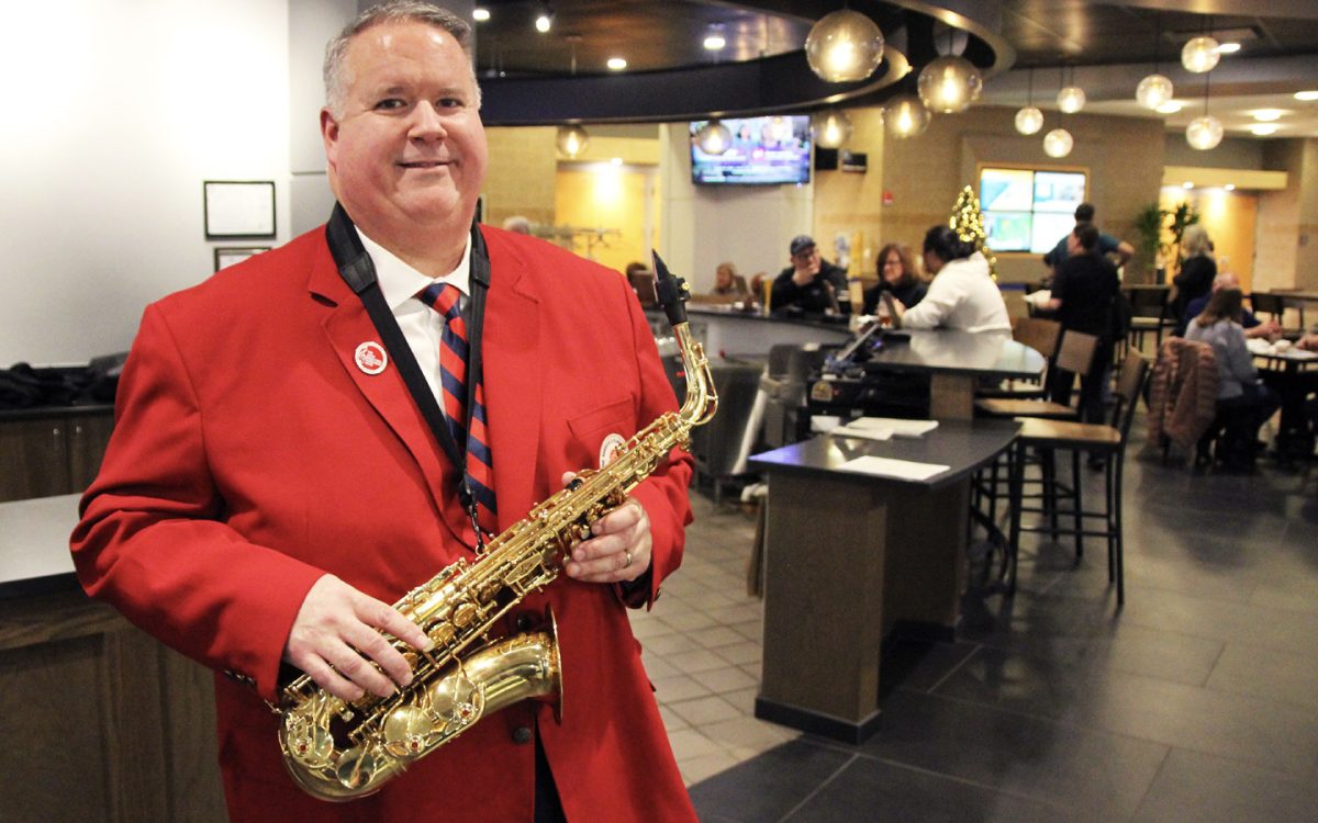 Jeff Groth, manager of The Craft Grille, takes a break from serving guests to showcase his Band Directors Marching Band uniform and alto saxophone. Groth was one of more than 300 performers marching in the Tournament of Roses Parade on Jan. 1. (Photo courtesy of Schoolcraft Marketing Department).