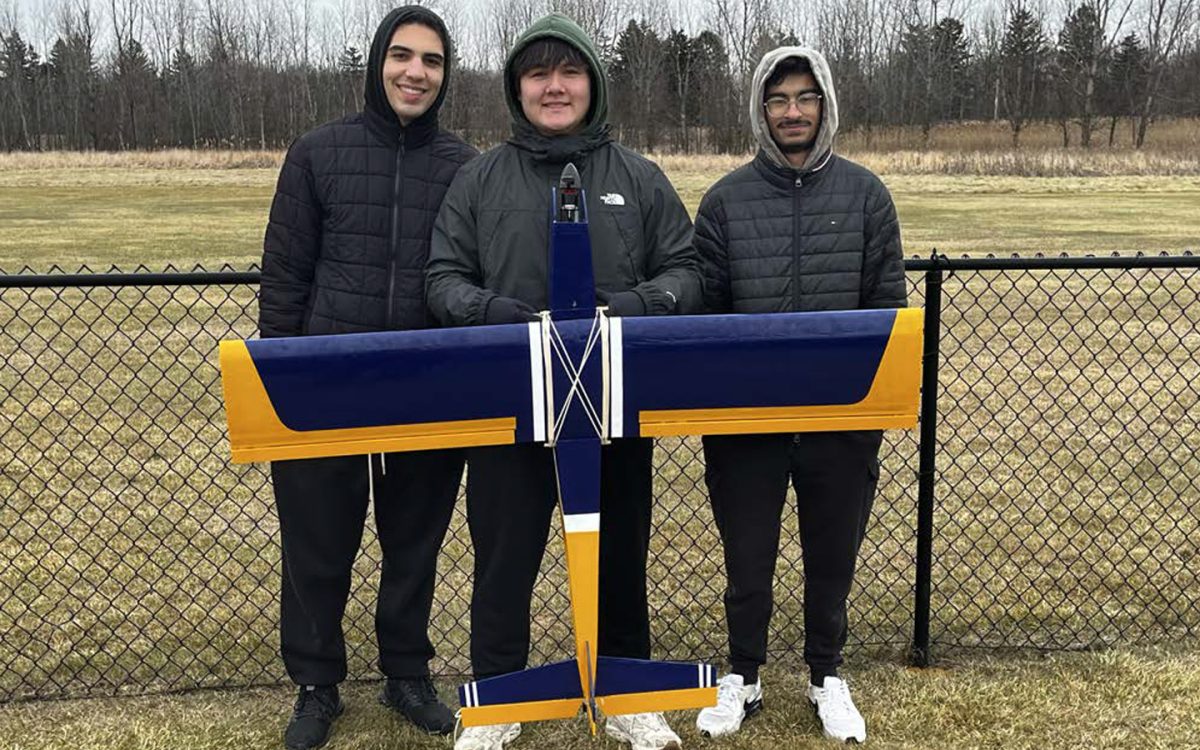 A3 Engineering Club members (From left to right) Hanz Saleem, Tobi Lile and Faizan Khurram pose with the R/C plane they constructed . (Photo courtesy of A3 Engineering Club)