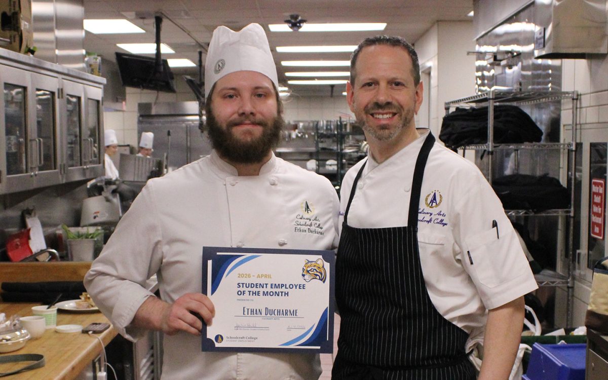 Ethan Ducharme (left) poses with Chef Brian Beland as he receives his Student Employee of the Month certificate.